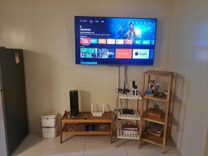 a flat screen tv hanging on a wall at Sandstone Unit Brenthill Condo in Baguio