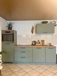 a kitchen with blue cabinets and a counter top at Gartenblick in Blankenheim