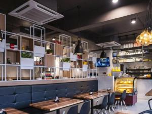 a restaurant with tables and chairs in a room at HP Hope Hotel in Johor Bahru