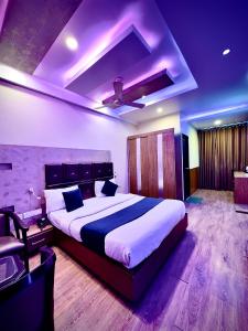 a bedroom with a large bed in a room at Hotel Cosmos in Lucknow +14 photos