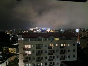 a fire burns in a building at night at Sandstone Unit Brenthill Condo in Baguio