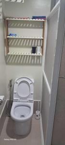 a small bathroom with a toilet in a room at Sandstone Unit Brenthill Condo in Baguio +9 photos