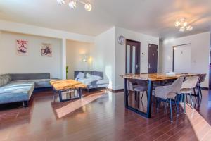 a living room with a couch and a table at North Furano House in Kami-furano