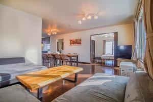 a living room with a couch and a table at North Furano House in Kami-furano