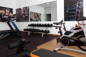 a gym with two treadmills and exercise bikes at Corundum Breeze Negombo in Negombo
