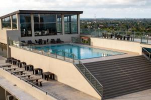 a swimming pool on the roof of a building at Corundum Breeze Negombo in Negombo