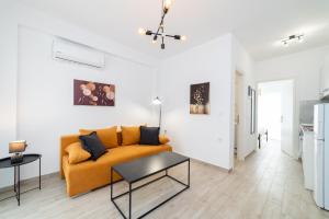 a living room with a couch and a table at Perla Stay Complex by Horizon Homes in Ofrínion