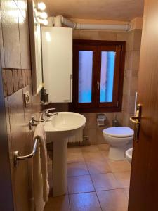 a bathroom with a sink and a toilet at Ca' Del Doge in Caorle