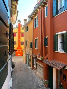 an alley in an old town with colorful buildings at Ca' Del Doge in Caorle