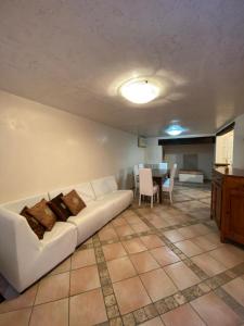 a living room with a white couch and a table at Ca' Del Doge in Caorle +7 photos