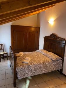 a bedroom with a large bed with a wooden headboard at Ca' Del Doge in Caorle