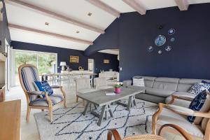 a living room with a couch and a table at Tour Maréchal - Villa d'Exception in LʼHerbergement