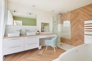 a bathroom with a sink and a mirror at Tour Maréchal - Villa d'Exception in LʼHerbergement