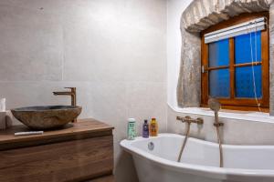 a bathroom with a tub and a sink and a window at Gite les fans in Prénovel +19 photos