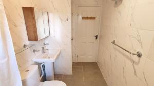 a bathroom with a toilet and a sink at Colindale 4 bedroom house with garden and 2 parking spaces in Colindale