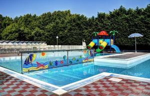 a large swimming pool with a playground with at Villaggio Camping delle Rose - Gatteo a Mare in Gatteo a Mare