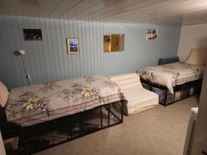 a bedroom with two beds and a table in it at Chambre d'Hôtes le Gachignard in Courlay