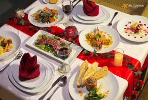 a white table with plates of food on it at Villa Tantawan Resort - Private Pool Villas in Kamala Beach