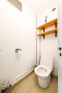 a bathroom with a white toilet in a room at L'Horizon in Noisy-le-Grand +29 photos