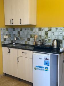 a kitchen with a sink and a counter top at у моря in Itʼkhvisi