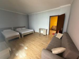 a living room with a couch and a bed at у моря in Itʼkhvisi