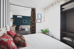 a bedroom with a large bed with red pillows at Laguna Boutique Apartments in Mestre +18 photos