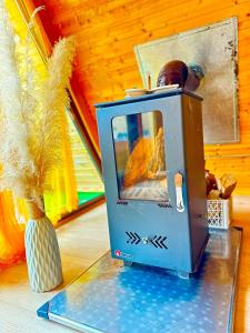 a small appliance sitting on a glass table with a vase at cottage sunrise house merisi in Merisi