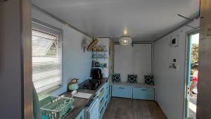 a kitchen with blue cabinets and a counter top at uMkhaKhaya Container Home in Westbrook