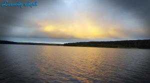 a rainbow in the sky over a large body of water at Lazurowy Zakątek in Życiny +5 photos
