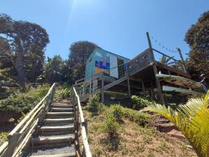 a house on a hill with stairs leading up to it at uMkhaKhaya Container Home in Westbrook