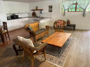 a living room with a wooden table and chairs at Milburn in Tokai