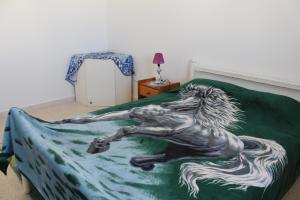 a statue of a horse laying on a bed at Résidence Chahed in Hammam Sousse