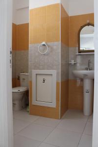 a bathroom with a sink and a toilet and a mirror at Résidence Chahed in Hammam Sousse +11 photos