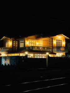 a building with lights in front of it at night at SAN Holiday Villa in Wadduwa