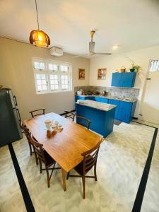 a kitchen with a wooden table and chairs in a room at SAN Holiday Villa in Wadduwa +7 photos