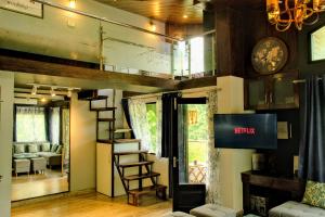 a room with a loft bed and a living room at Kavi's Vacation Homes - Peaceful stay in sainj valley in Sainj