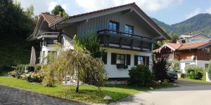 a house with a black and white at Ferienwohnung Lanzinger inkl. Chiemgaukarte in Ruhpolding