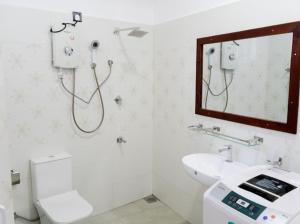 a bathroom with a shower and a sink and a mirror at Ocean River View in Ambalangoda