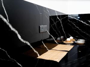 a kitchen with a counter and a table with plates at Ocean River View in Ambalangoda +4 photos