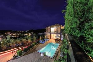 a house with a swimming pool at night at Villa Naisy in Tsilivi