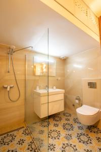 a bathroom with a shower and a toilet and a sink at Aurora Apartment in Afitos +26 photos