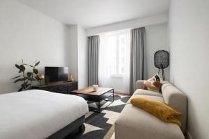 a hotel room with a bed and a couch at 2 Bedroom Apartment for Families and Business, Tram and Bus in Front in Antwerp