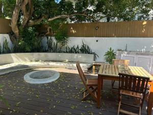 a patio with a table and chairs and a fire pit at Lakaz Zoizo in Crève Coeur +4 photos