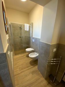 a bathroom with a shower and a toilet and a sink at Casale La Rosa Azzurra in Ponte Buggianese +53 photos