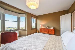 a bedroom with a large bed and windows at Hastings View in Hastings