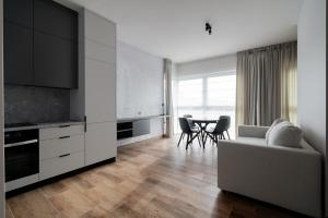 a living room with a couch and a table at Apartamenty Szelągowskiej in Raszyn
