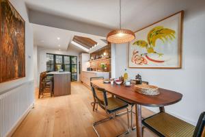 a dining room and kitchen with a table and chairs at Hastings View in Hastings