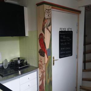 a kitchen with a door with a sign on it at Tour Rose in Frangy