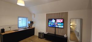 a room with a flat screen tv on a wall at Sullane Weirs in Macroom +11 photos