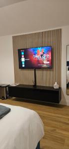 a bedroom with a flat screen tv on a wall at Sullane Weirs in Macroom